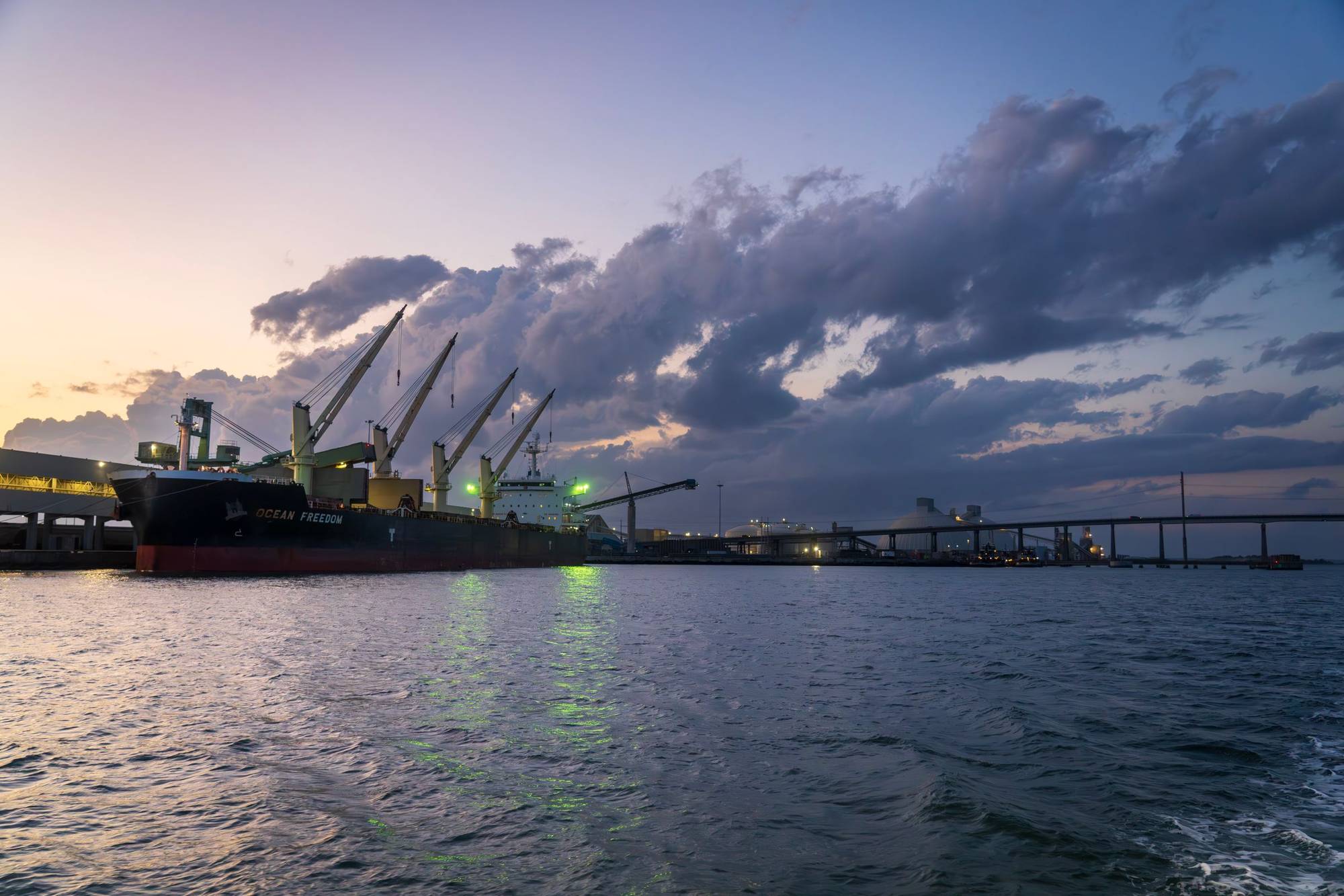 Bulk carrier at a port at dusk (illustrative stock photo)